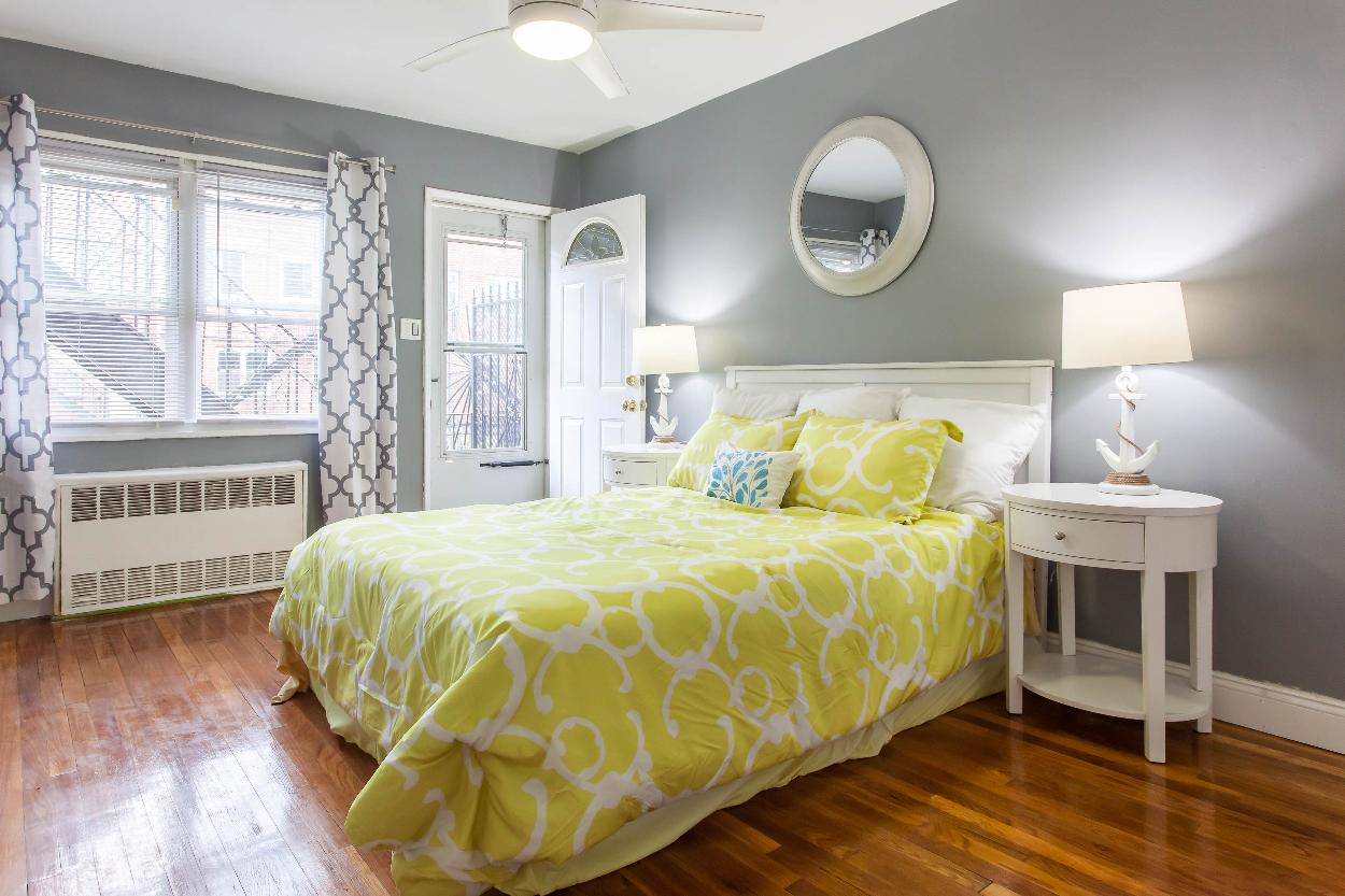 First Floor: Bedroom 1 with beautiful hardwood floors, natural light, and spacious closet