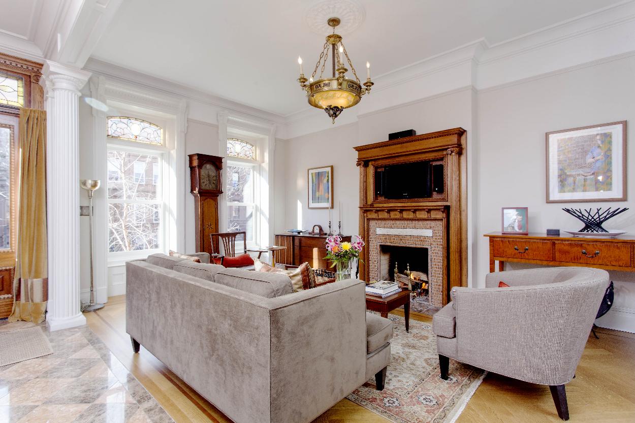 Front Parlor / Entry Foyer- original stained glass, Jefferson shutters & wood-burning fireplace.