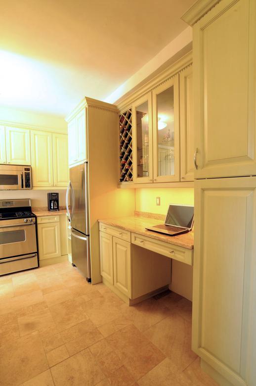 Built-in office area with wine rack and glass display cabinet