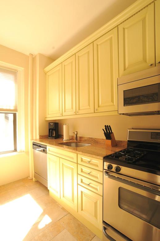 Kitchen with granite counter tops and new KitchenAid refrigerator