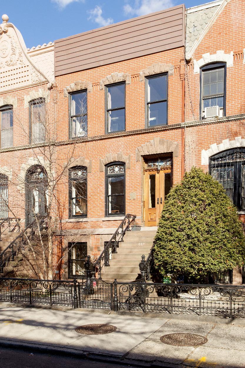 Exterior Front: original Brownstone stoop. New Wood Windows and mahogany entry door.