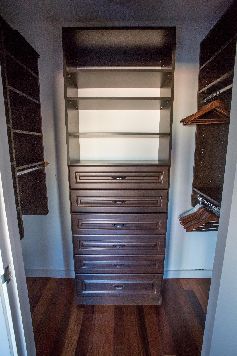 Bedroom closet with shelving unit installed