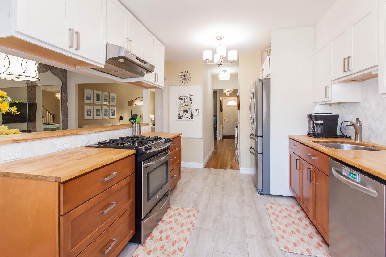 Second Floor: Kitchen w stainless steel appliances, white and wood shaker cabinets, lots of storage